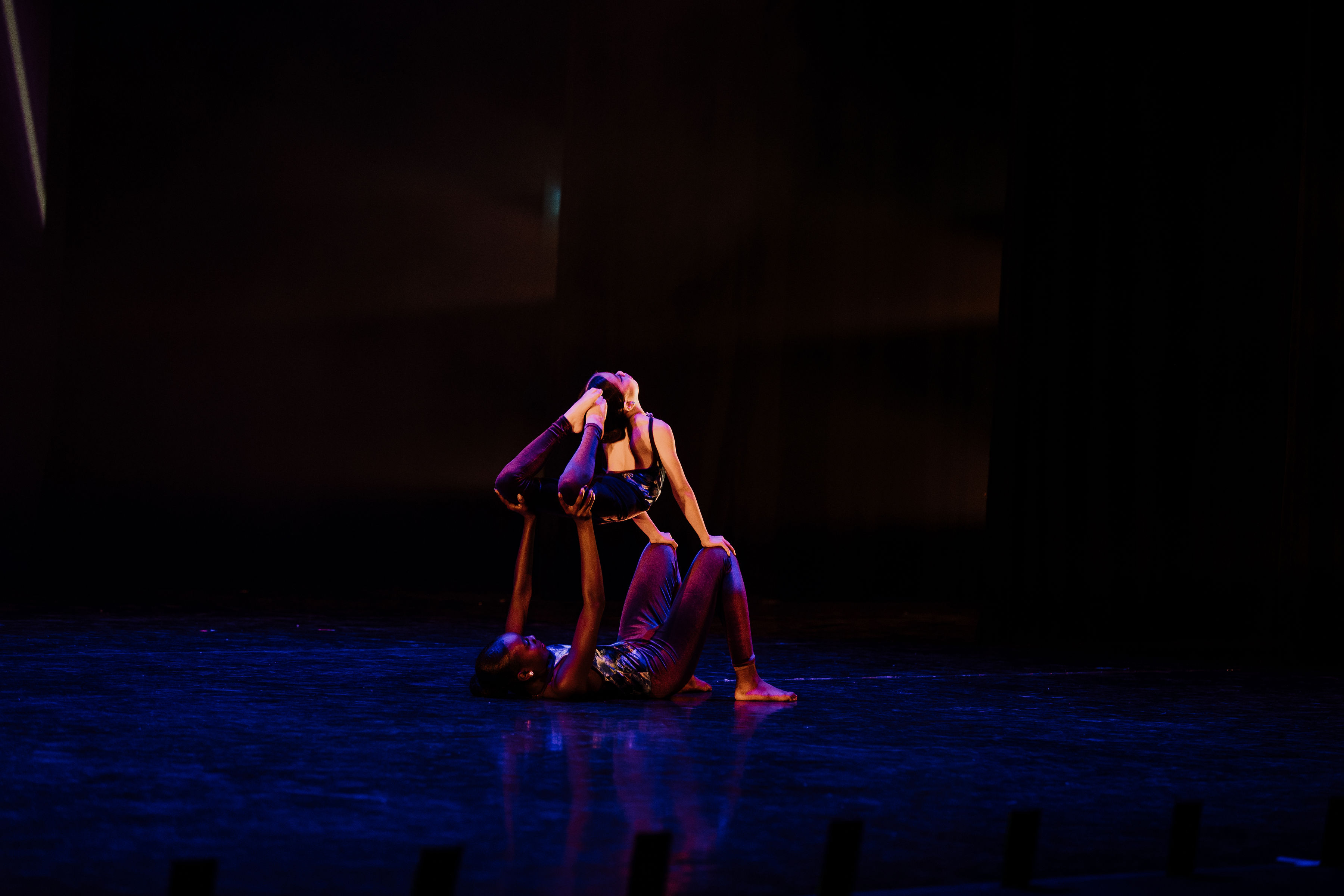 Two dancers performing an Acro routine on stage