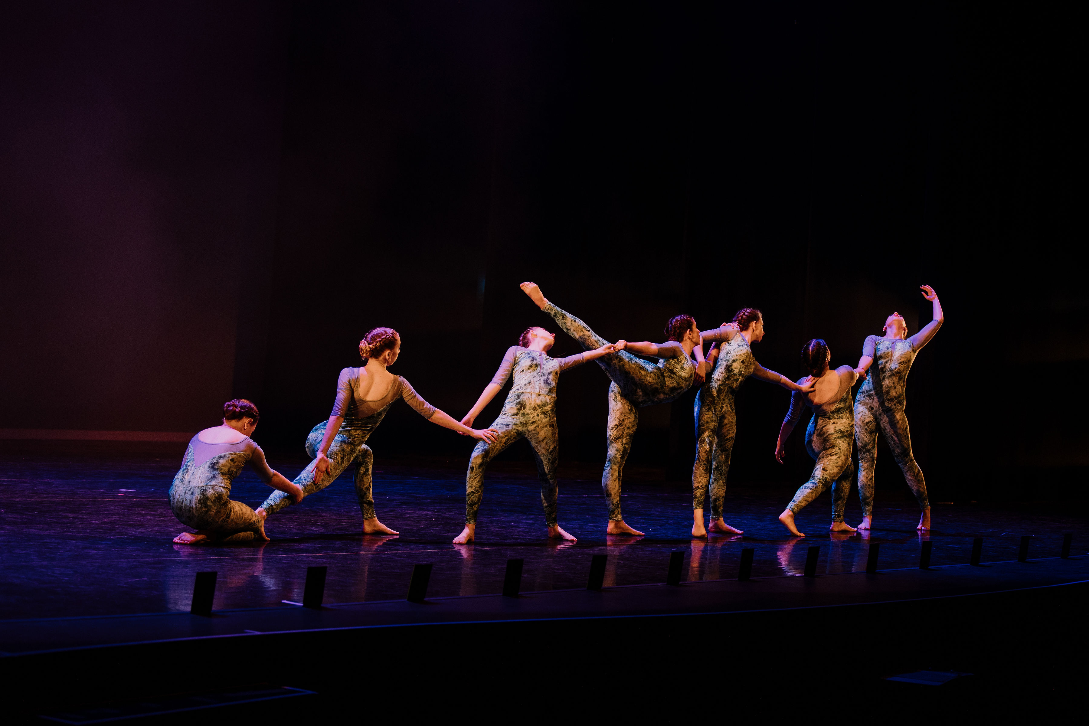 Large contemporary group dancing on stage
