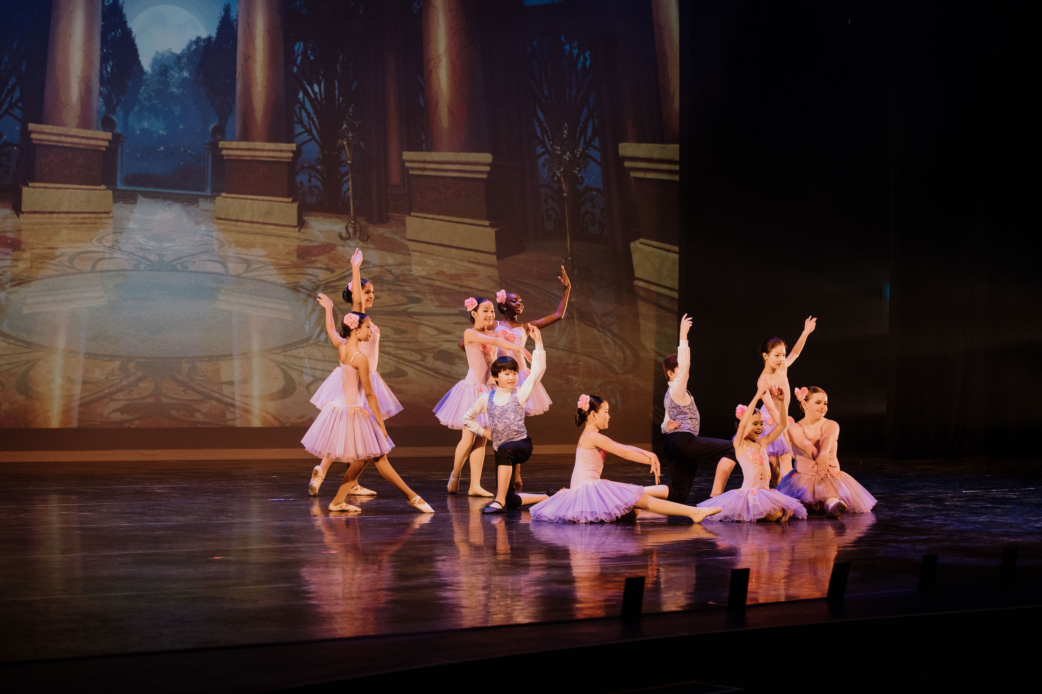 Large ballet group dancing on stage