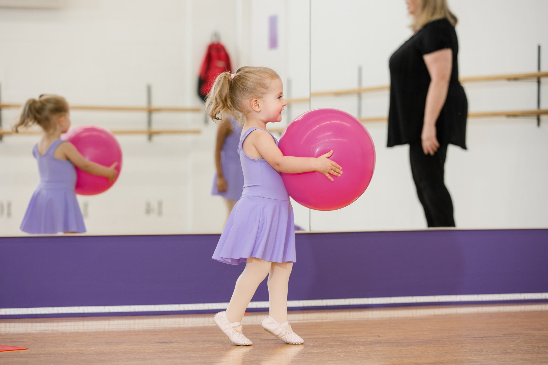 Young dancer holding a large ball